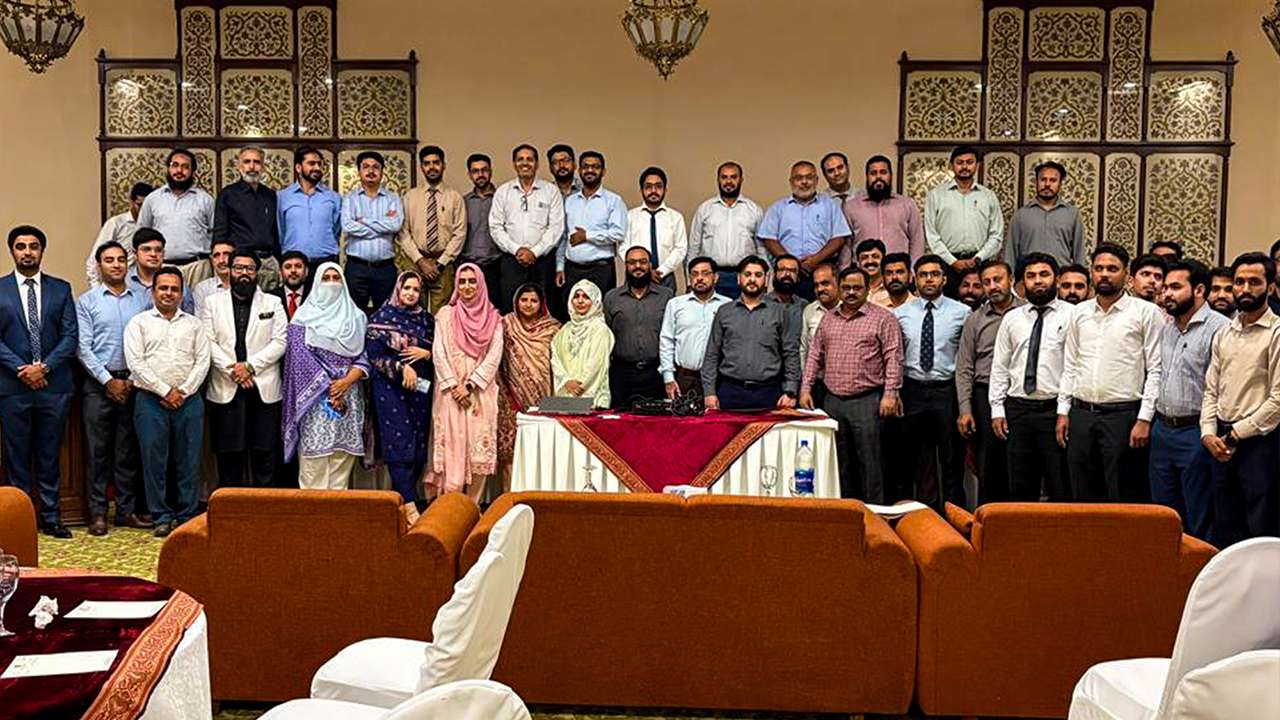 Employees participating in corporate wellness seminar focused on mental health and workplace well-being