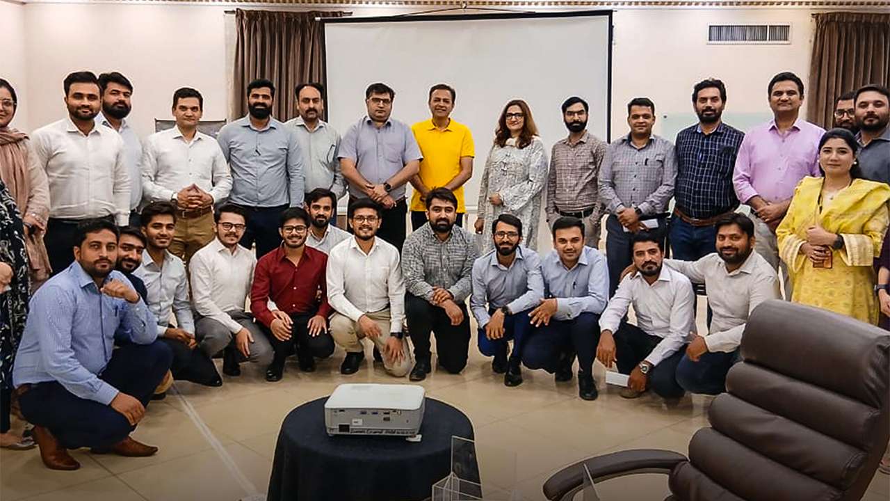 Mental health awareness session in Lahore by MedIQ and Abbott Corporate wellness event with Fatima Memorial experts Abbott employees attending wellness session in Faisalabad Dr. Usama Bin Zubair speaking Shifa International experts